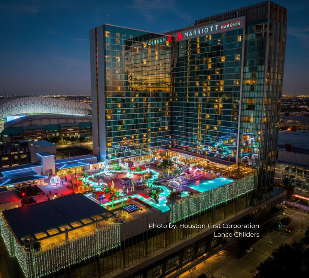 Houston Marriott Marquis Hotel with view of the pool lit up at night