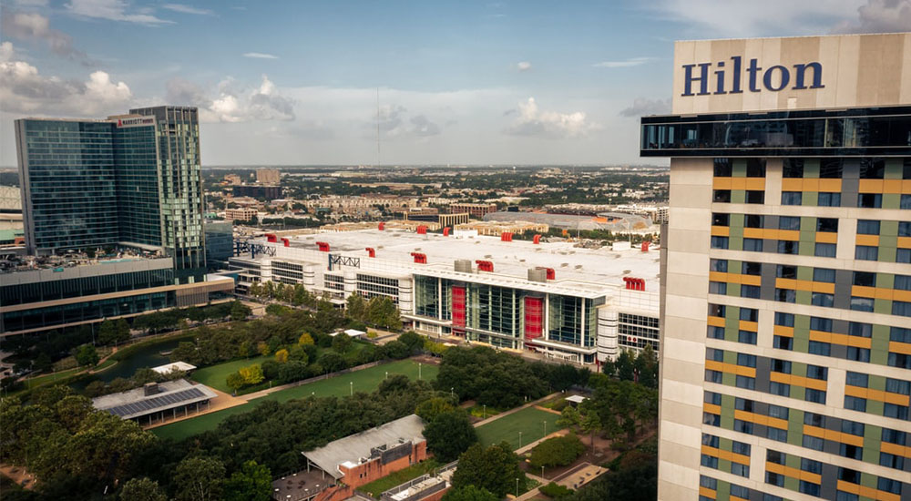 High view of Avenida Houston convention center district with Hilton hotel in the foreground and George R. Brown Convention Center, Marriott Marquis and greenspace in the background.