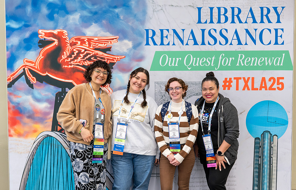 Group of attendees at TLA Annual Conference standing in front of selfie wall