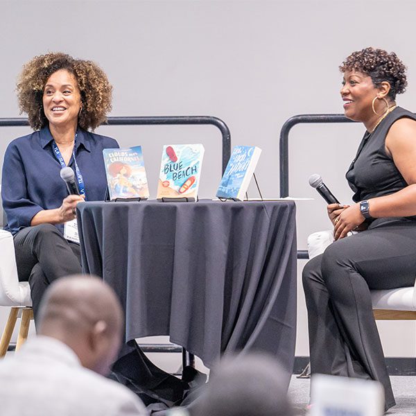 Author Karyn Parson onstage with host at Black Caucus Round Table event