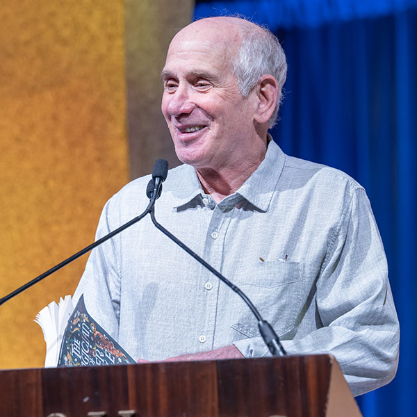 Louis Sachar-TLA 2025 Keynote at the podium on stage at TLA's Annual Conference