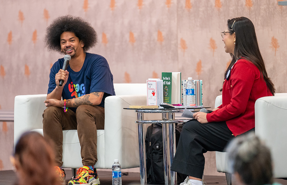Author and speaker Mychal Threets speaking onstage with interviewer at TLA 2025 Annual Conference.
