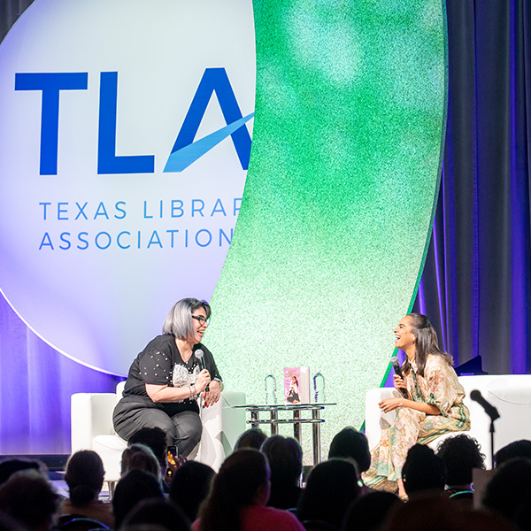Misty Copeland-TLA 2025 Keynote sitting in a chair with interviewer on stage at TLA's Annual Conference