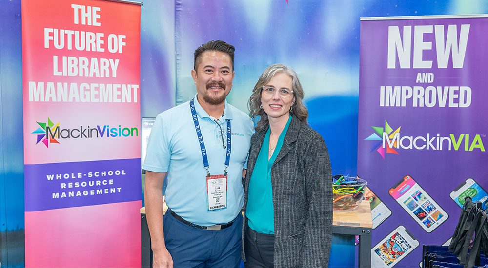 Male sponsor and female TLA president standing in a booth at TLA Annual Conference.