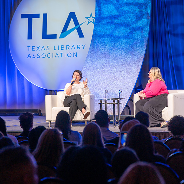 TLA 2025 Keynote Speaker Taylor Jenkins Reid onstage with interviewer