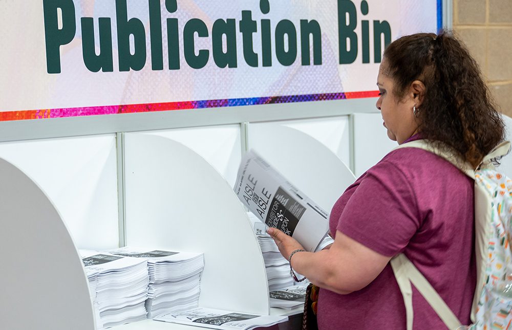 TLA Aisle by Aisle Book being read by an attendee