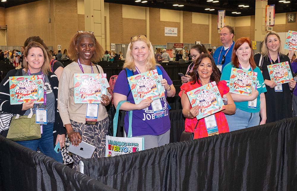 Group of attendees getting books signed in the TLA Annual Conference Authors Area