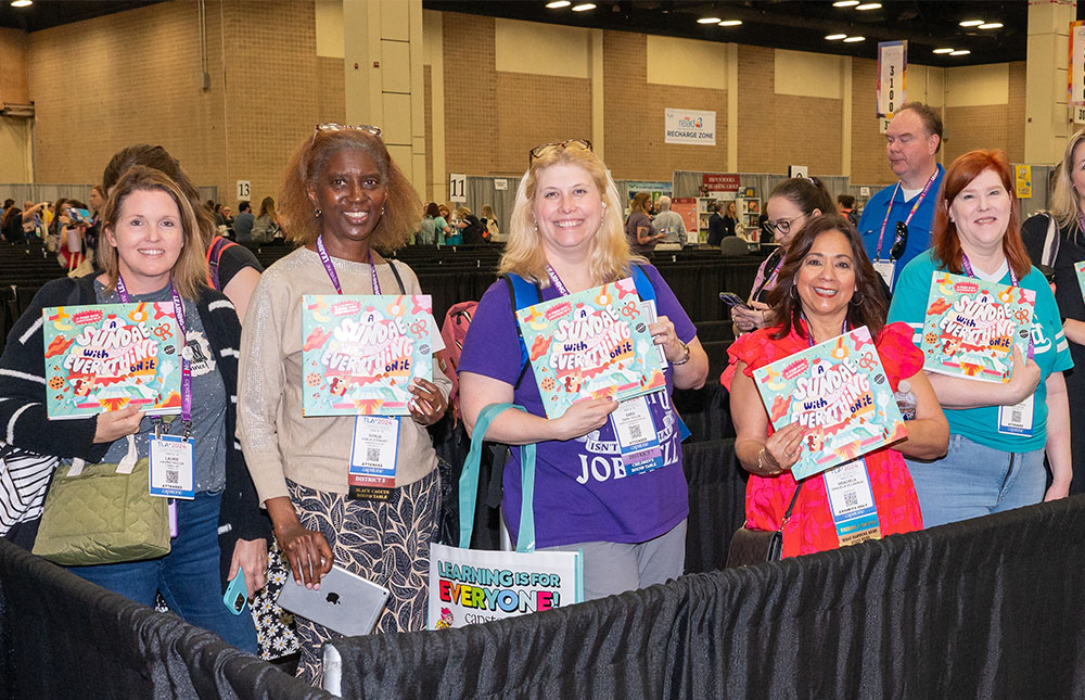Group of attendees getting books signed in the TLA Annual Conference Authors Area
