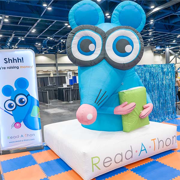 Large inflatable blue mouse in a exhibit booth at TLA 2026 Annual Conference